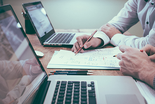 A Kornitzer Capital Management team reviewing an institutional mandate